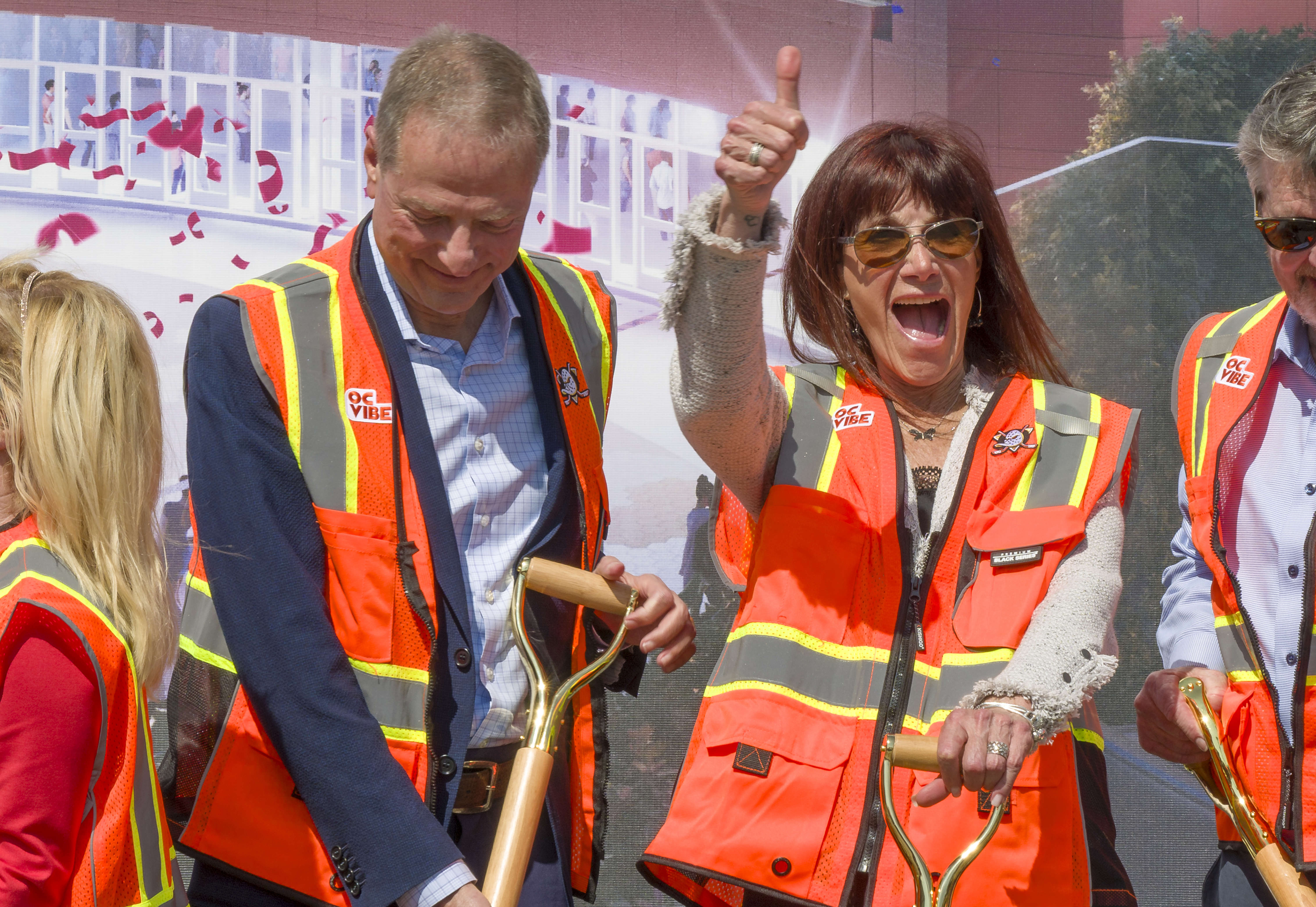 Susan Samueli, right, gives a thumbs up after her and...