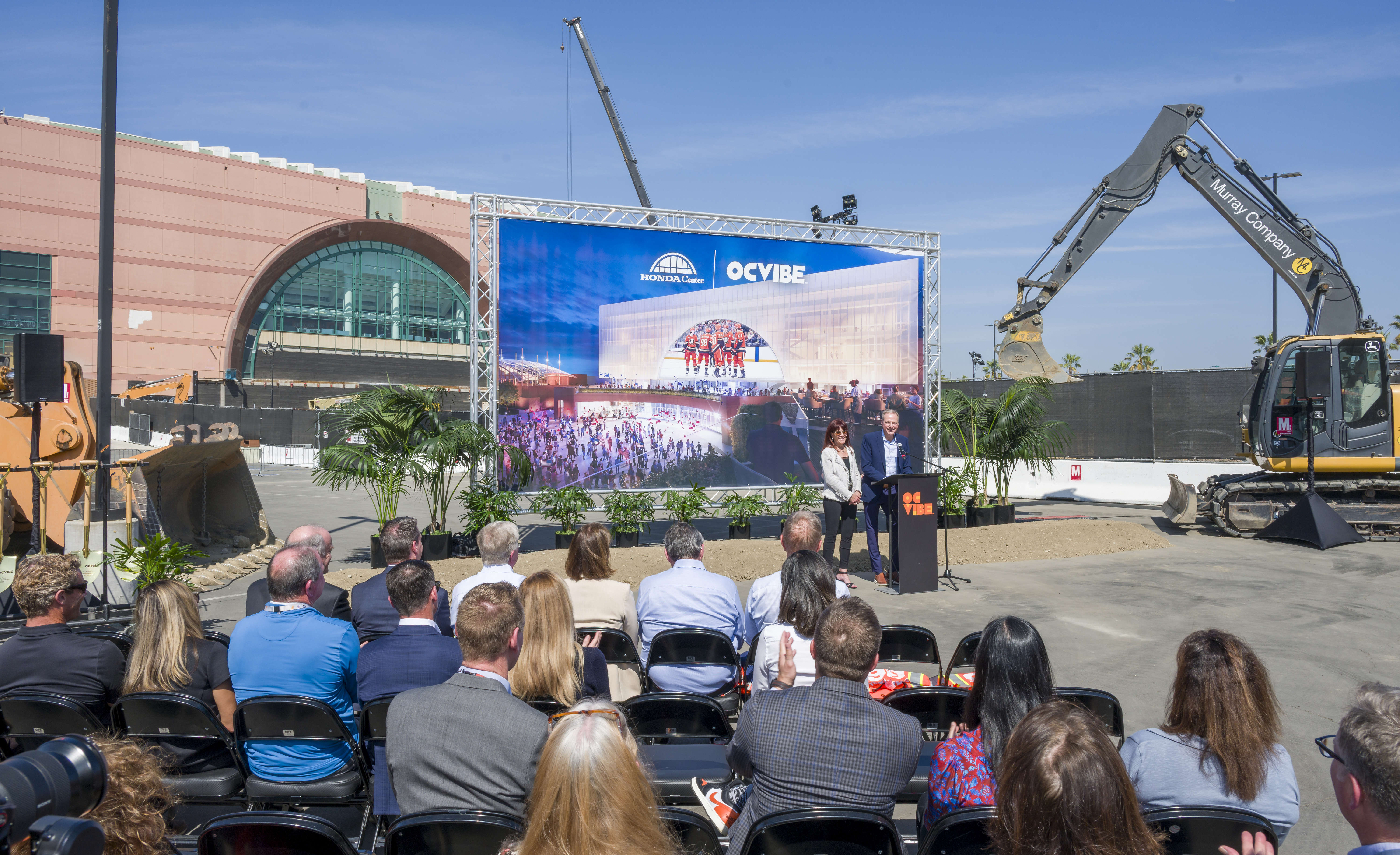 Anaheim Ducks owners, Henry and Susan Samueli, at podium, speak...
