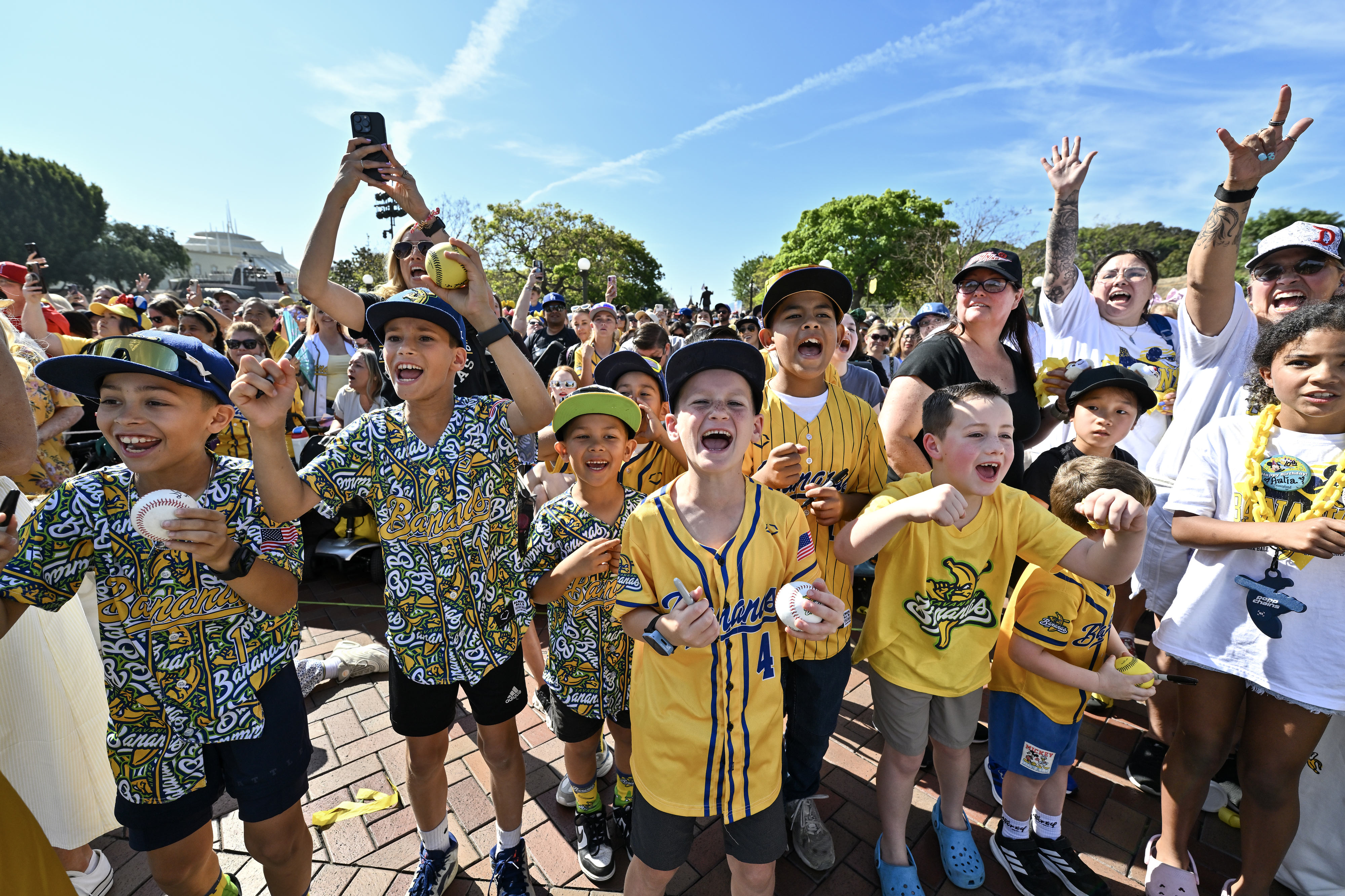 Carter Mundy, 7, center, joins other fans as they cheer...