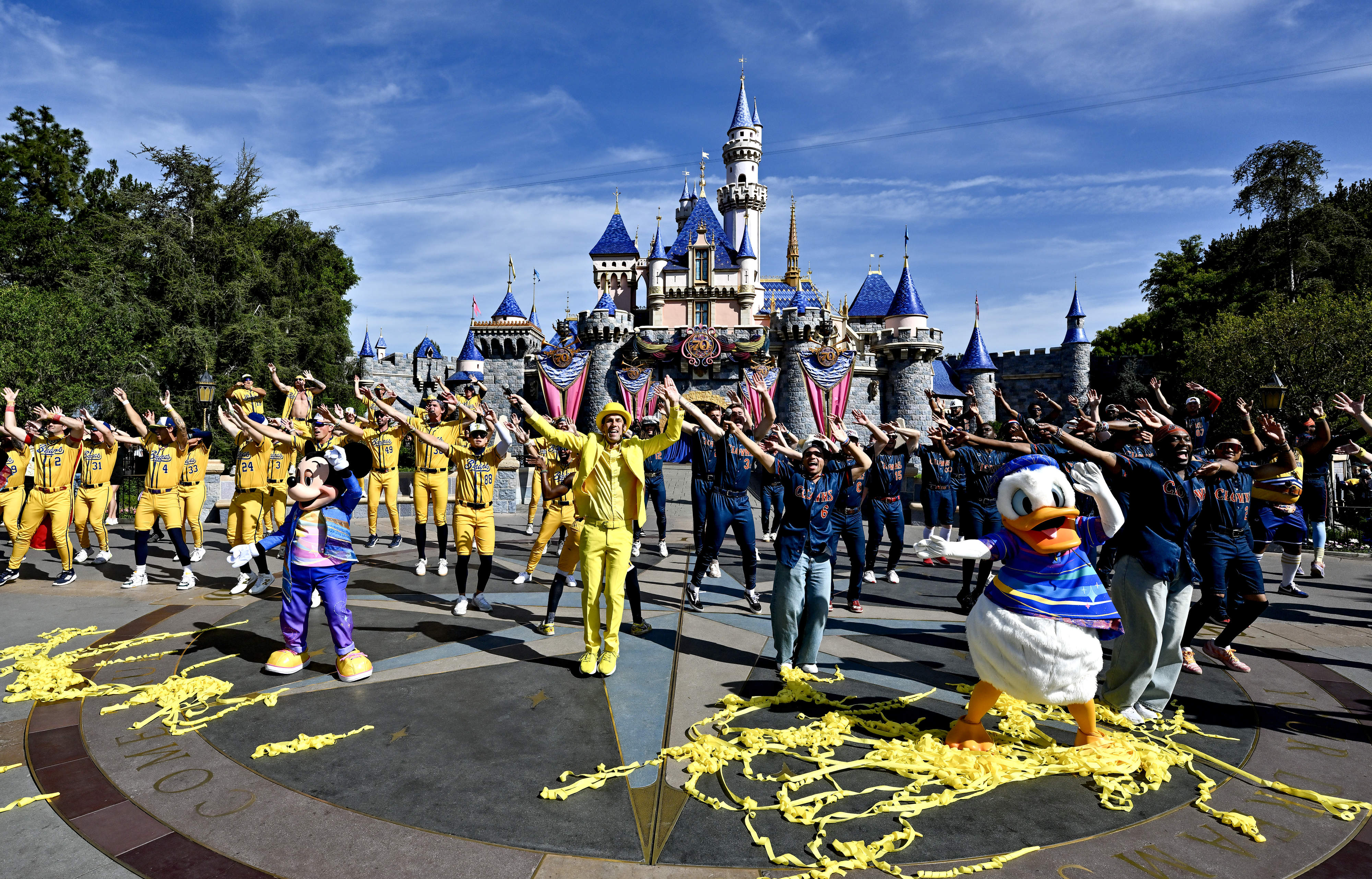 The Savannah Bananas and Indianapolis Clowns perform in front of...