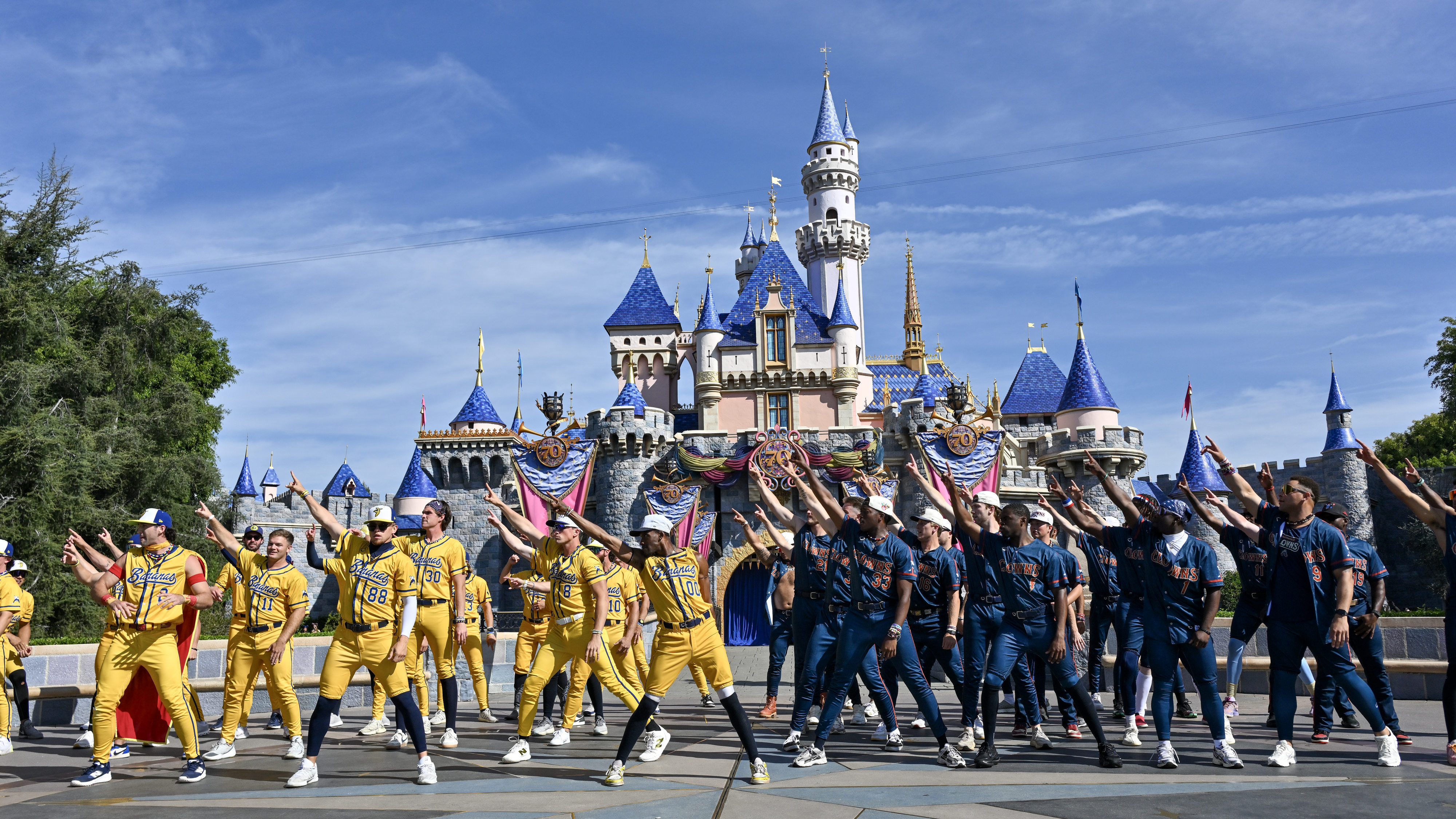 The Savannah Bananas and Indianapolis Clowns perform in front of...