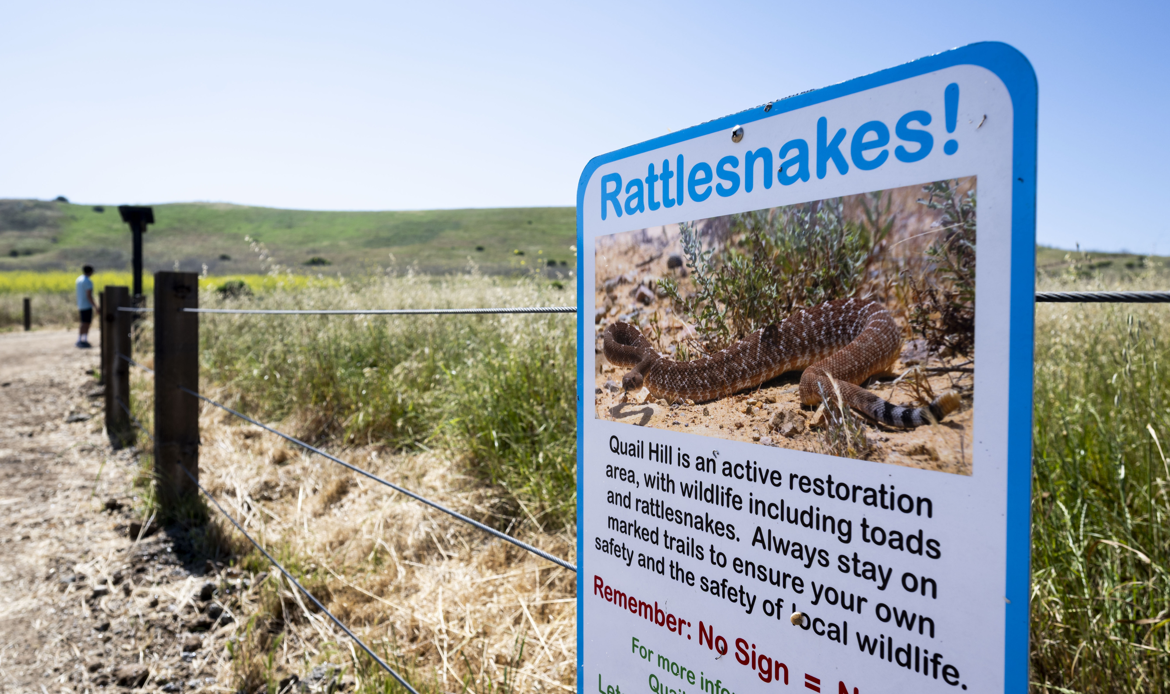 A sign warns visitors about rattlesnakes on the Quail Hill...