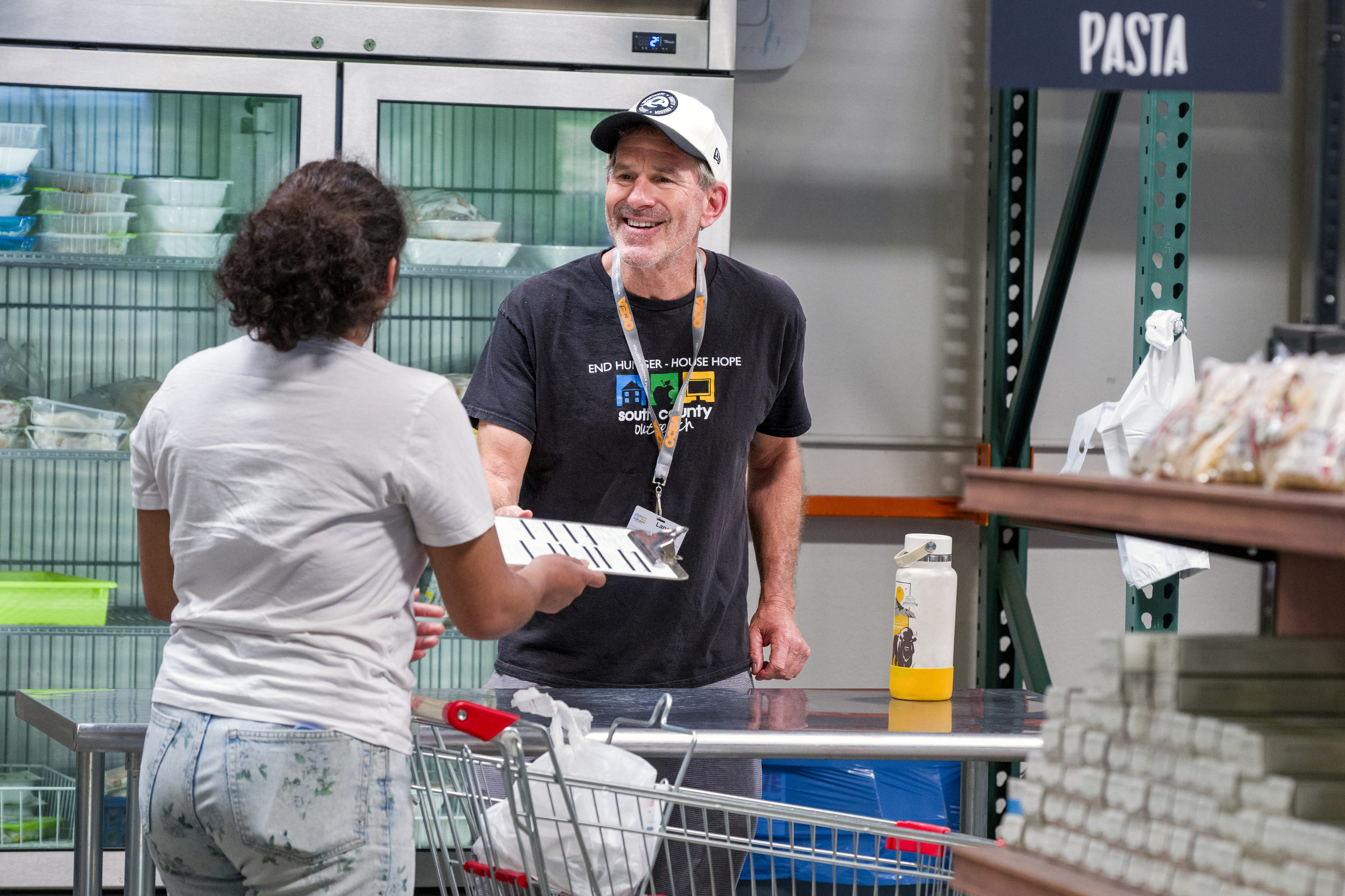 Lance Malis, right, assists a guest at the South County...