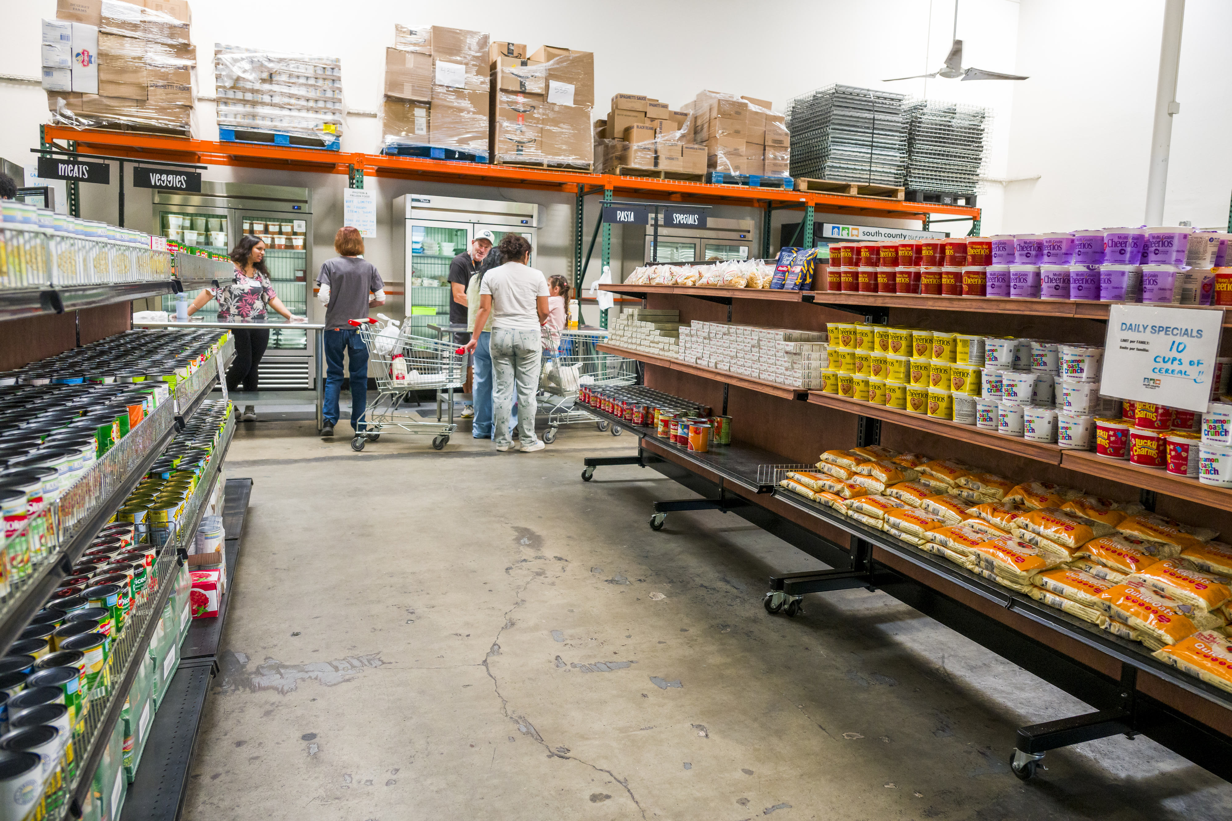 Guests get help from volunteers at the South County Outreach...