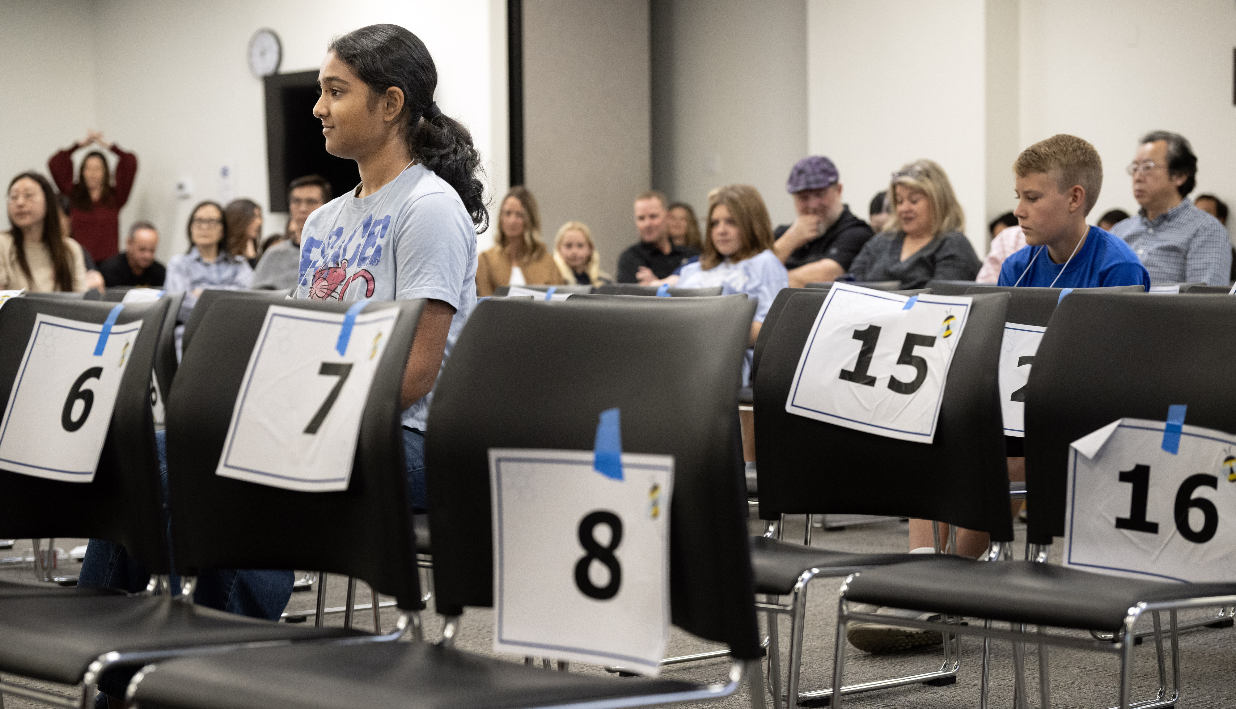 Advika Prasad, 14, is surrounded by the empty chairs of...