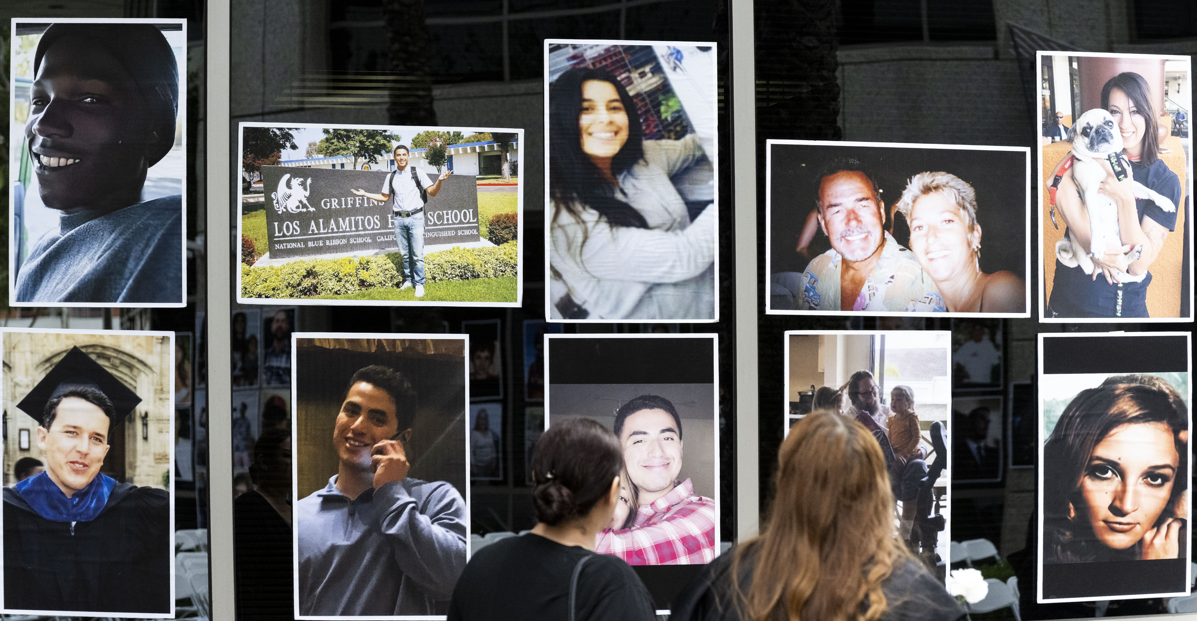 People look at portraits of crime victims during the Crime...