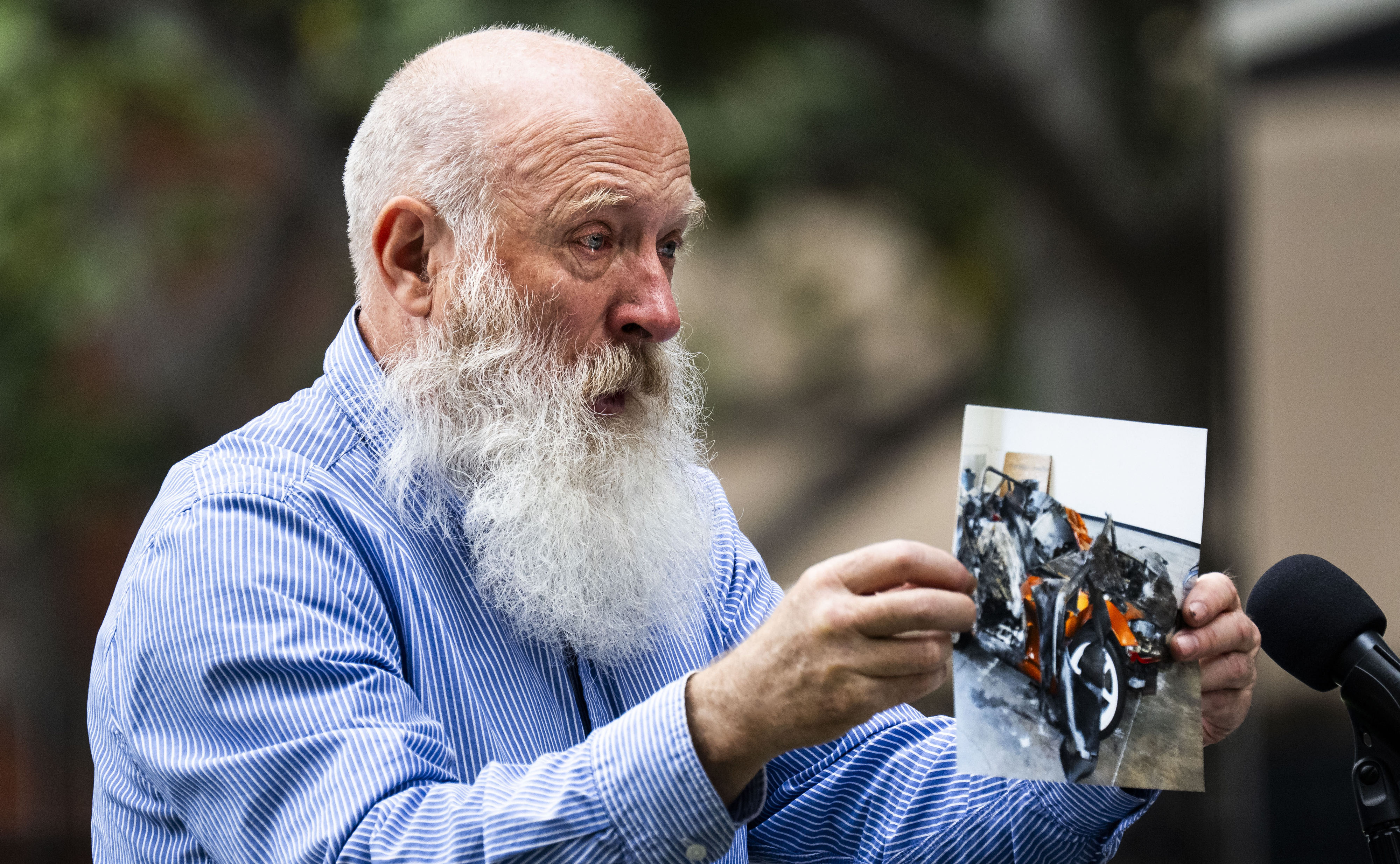 Anatoly Varfolomeev shows a photo of the remains of the...