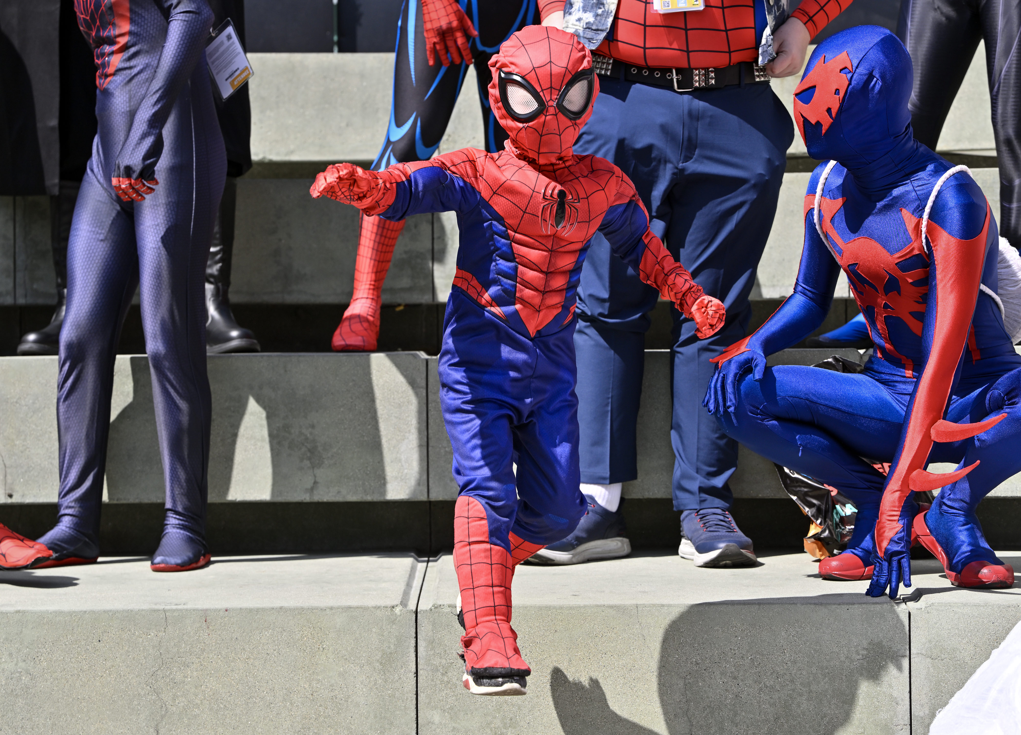Owen Nease, 3, dressed as Spider-Man, jumps from a photo...