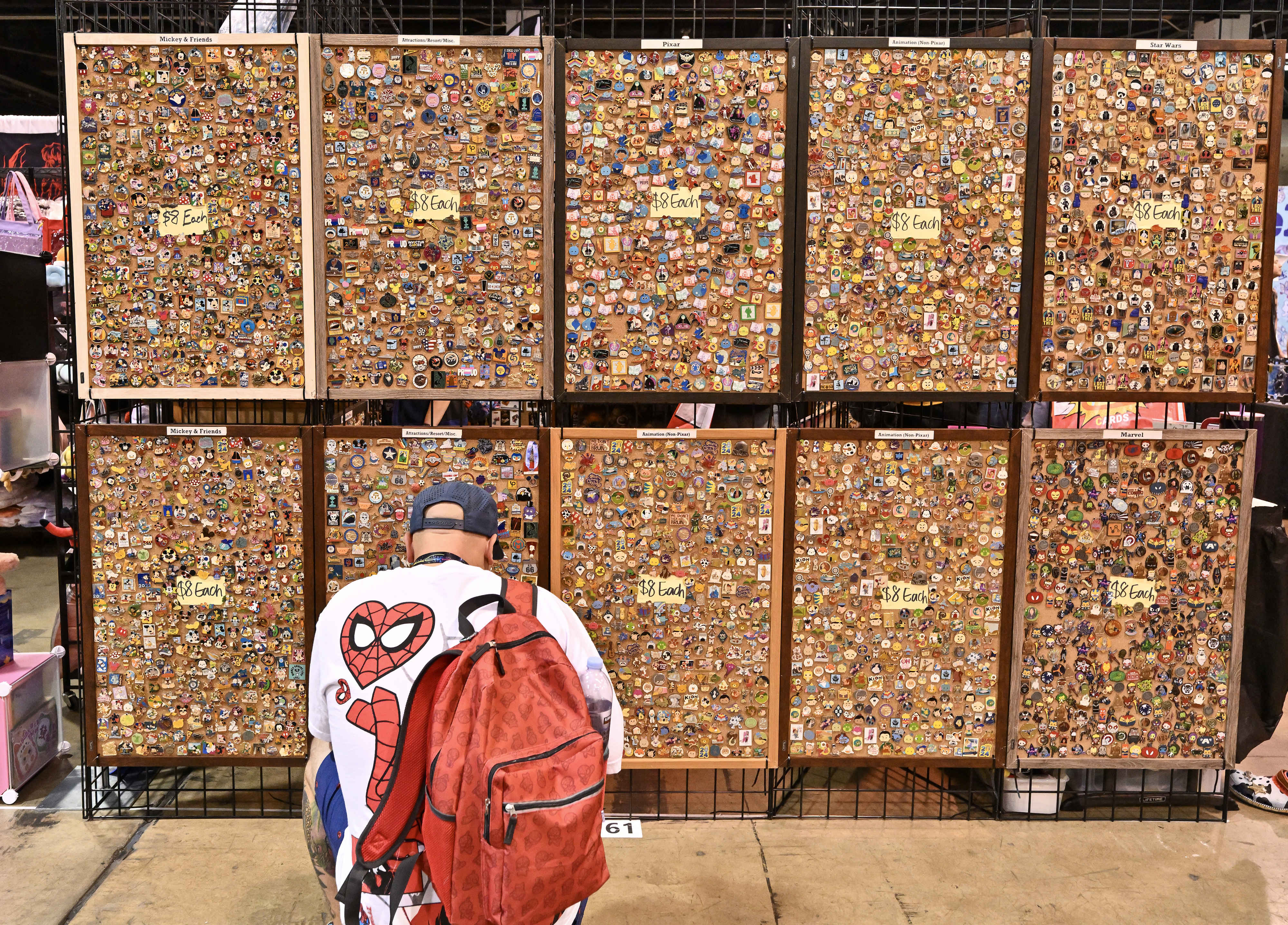 A visitor at WonderCon checks out pins at the Anaheim...