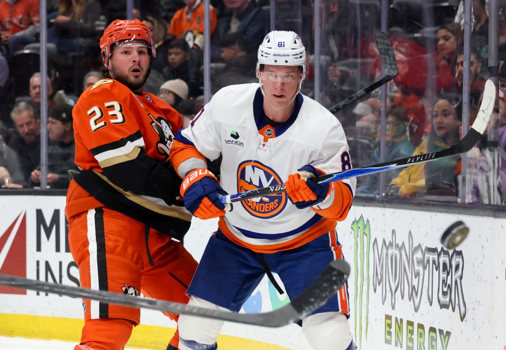 Ondrej Palat passes the puck after getting pressured by Mason McTavish during the Islanders' blowout road loss to the Ducks.