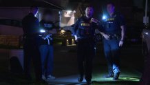 San Diego police officers talk to a young-looking individual seen leaving an illegal party in January in Otay Mesa.