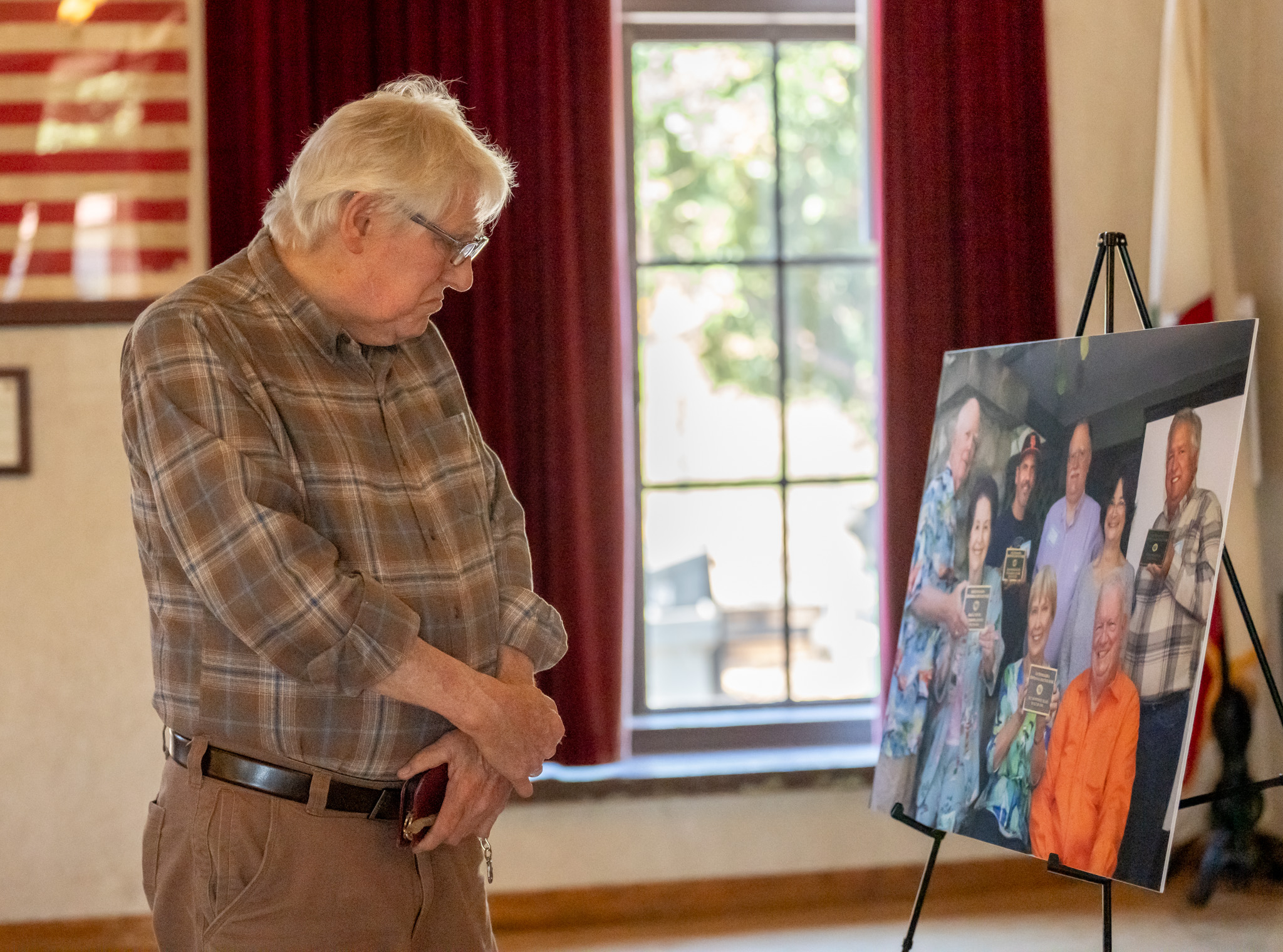 Bill Cross views a photo during a ceremony for Joanne...