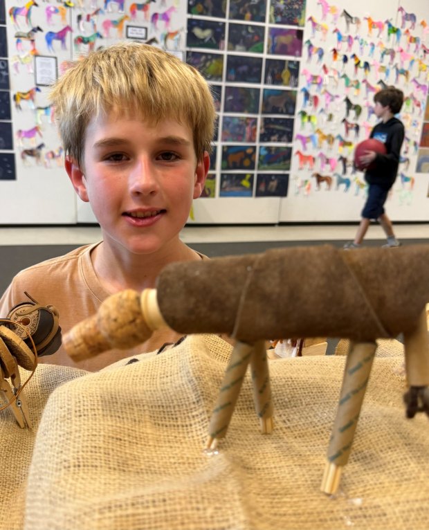 Fifth grader Emmett Summers with the horse sculpture he made from found and recycled materials in the style of sculpturist Deborah Butterfield. (Erin Pennell)