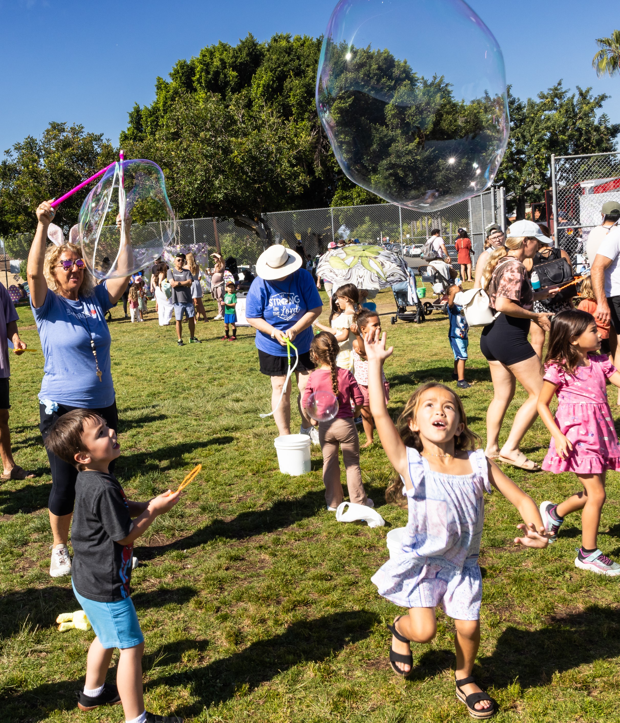 Children play with bubbles created by professional bubble former Jill...
