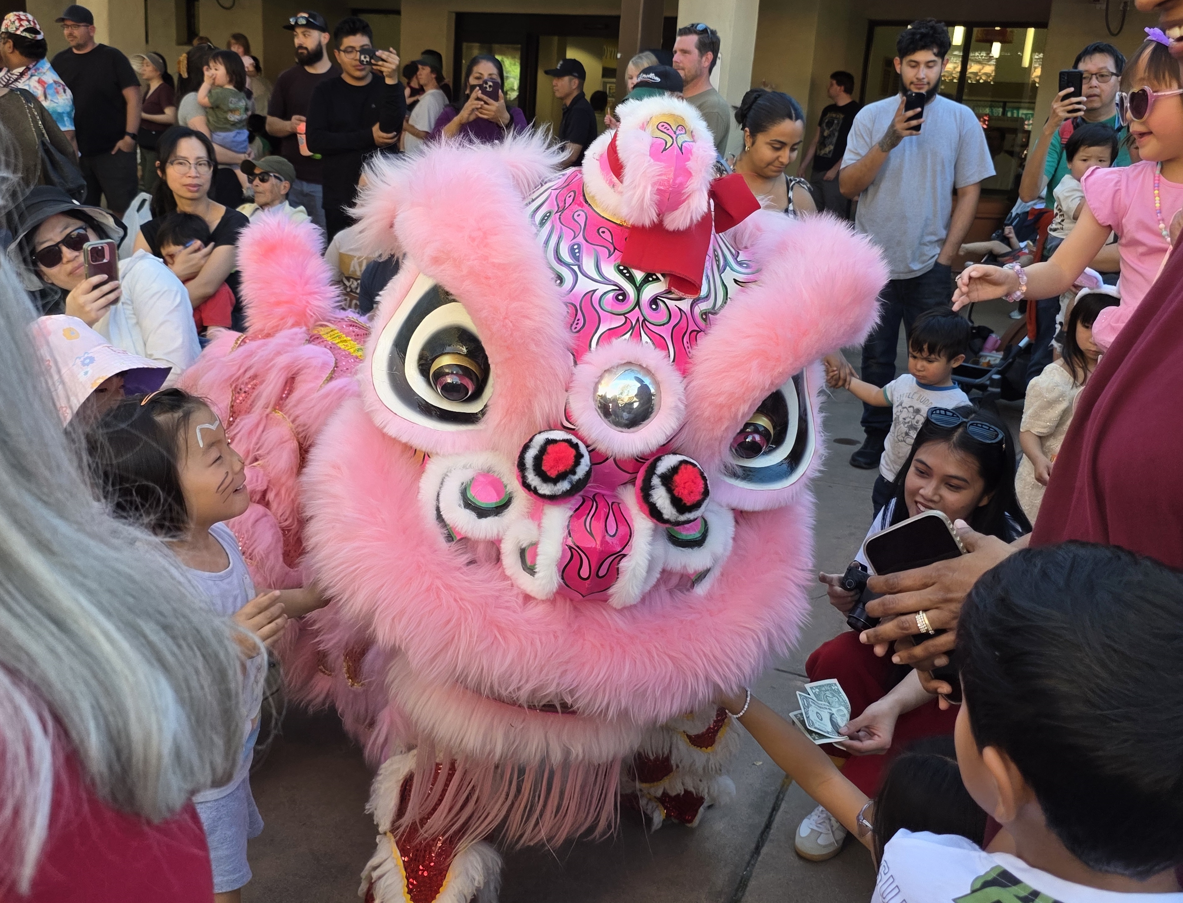 Lion dancers mingled with a crowd of more than 625...