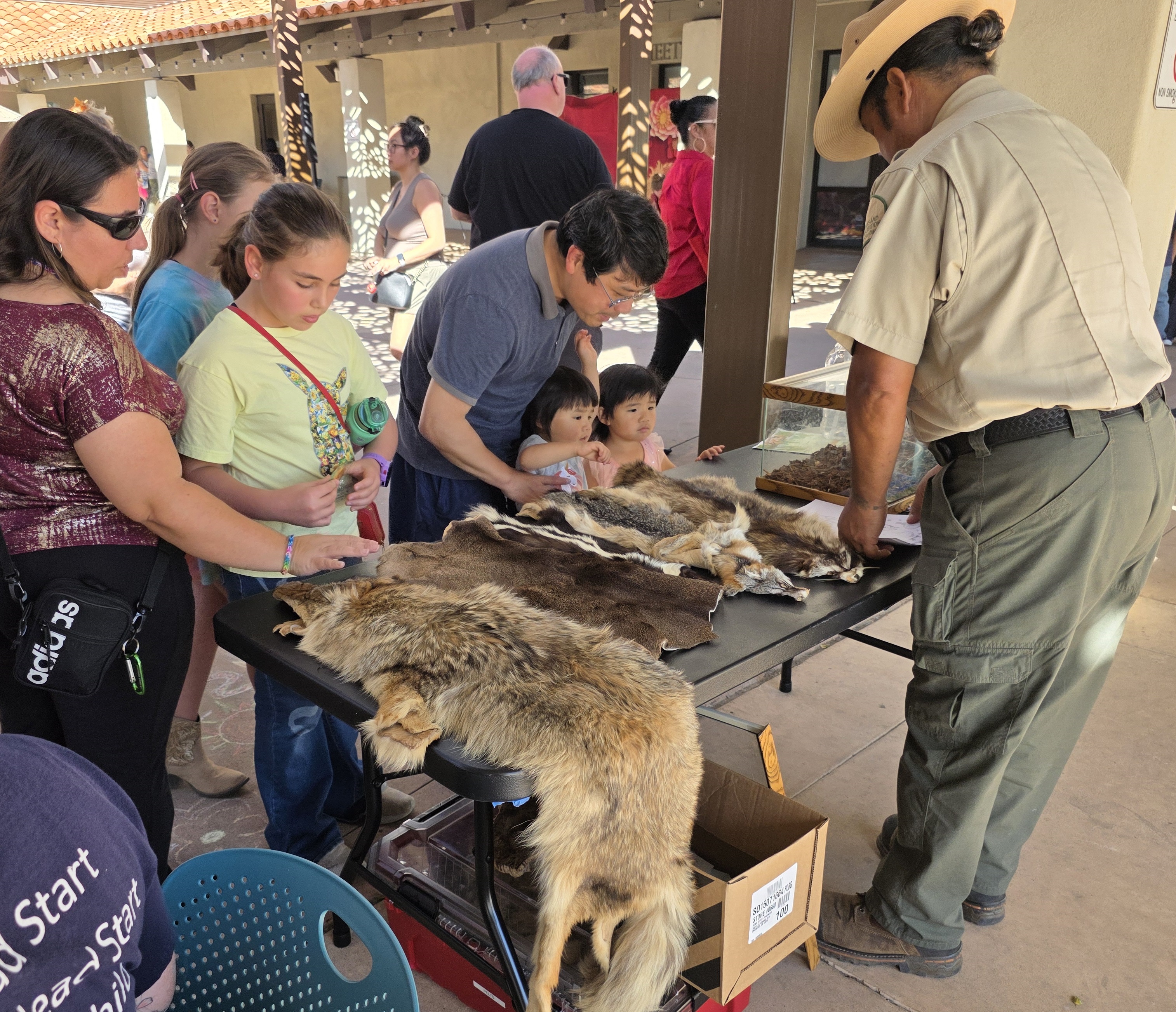 Park Ranger Alejandro Santos, right, displayed animal pelts during the...