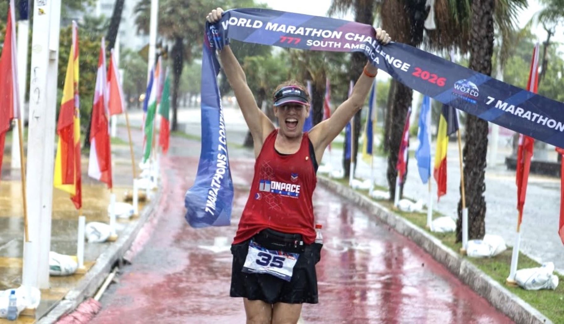 Tracy Roth holding the finisher ribbon in Fortaleza, Brazil on...