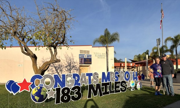 Tracy and Brad Roth outside Tierra Bonita Elementary in Poway, where a congratulatory sign welcomed her return on Feb. 9. (Courtesy of Tracy Roth)