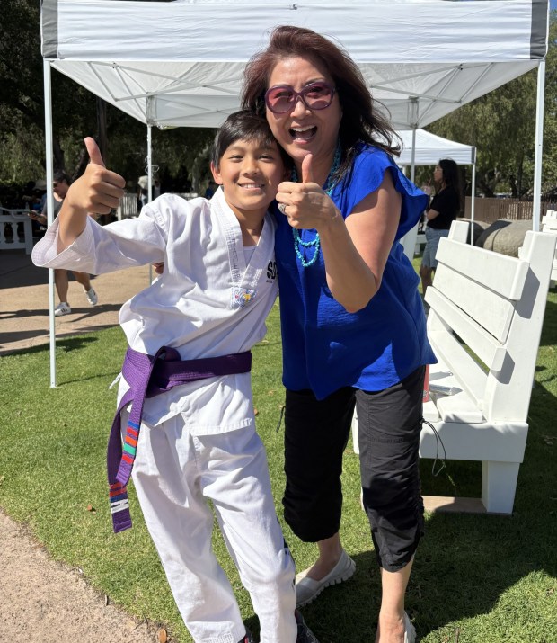 James Kim with his mother, Carita Kim, who is a PUSD parent ambassador. James performed with Elite TKD Academy/SDTC in the gazebo. (Amy Shireman)
