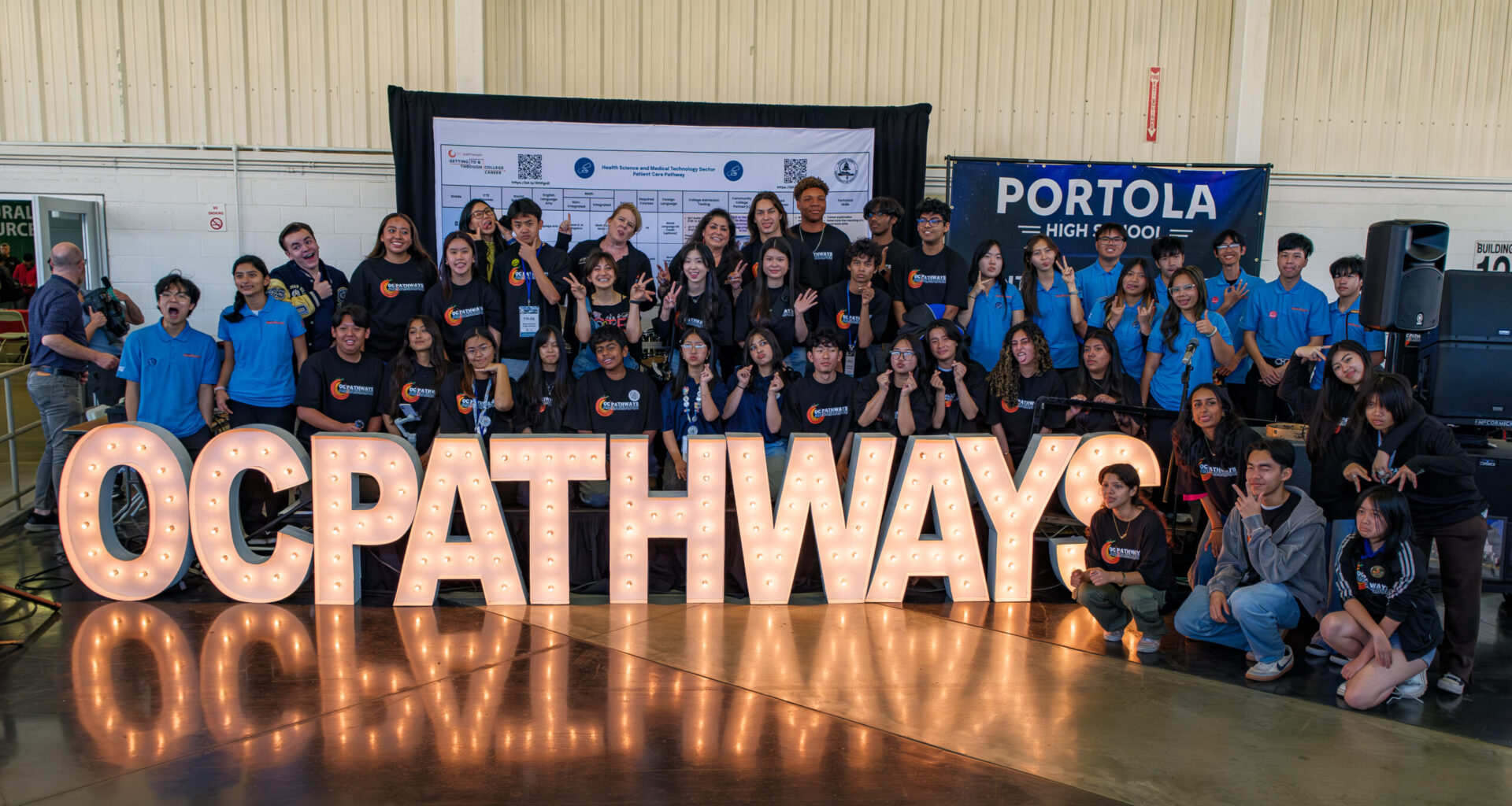OCDE Executive Director Kathy Boyd and Administrator Kim Goodwin pose with the OC Pathways student ambassadors at the 12th annual OC Pathways Showcase at the OC Fairgrounds.