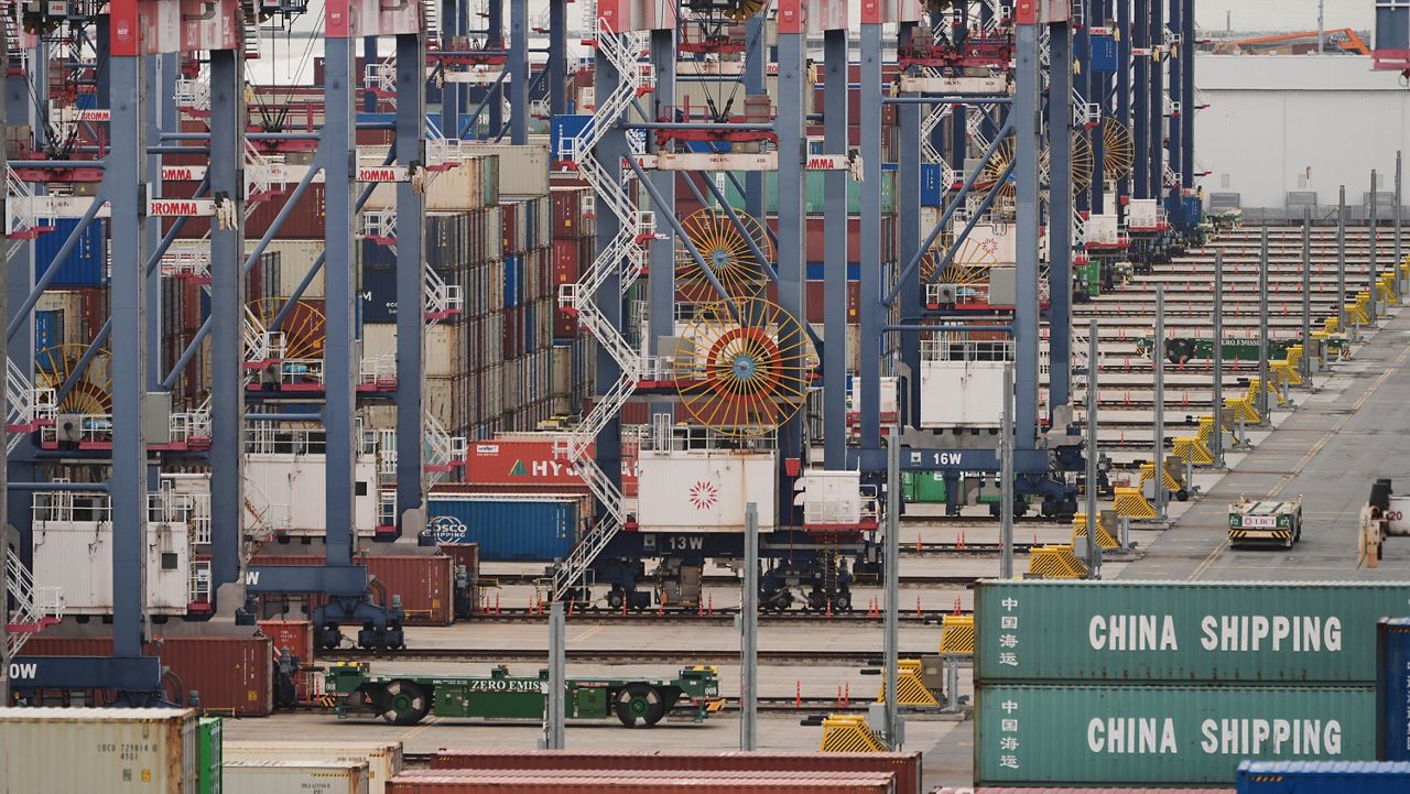 Containers are stacked at the Port of Long Beach Friday, Feb. 20, 2026, in Long Beach, Calif. (AP Photo/Damian Dovarganes)