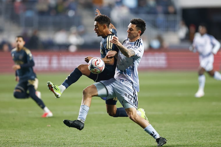 Union defender Japhet Sery Larsen (left, center) and San Jose forward Preston Judd battle for possession in the first half on Saturday's loss to the Earthquakes at Subaru Park.
