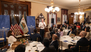 A photo of Governor Gavin Newsom speaking to a group of people