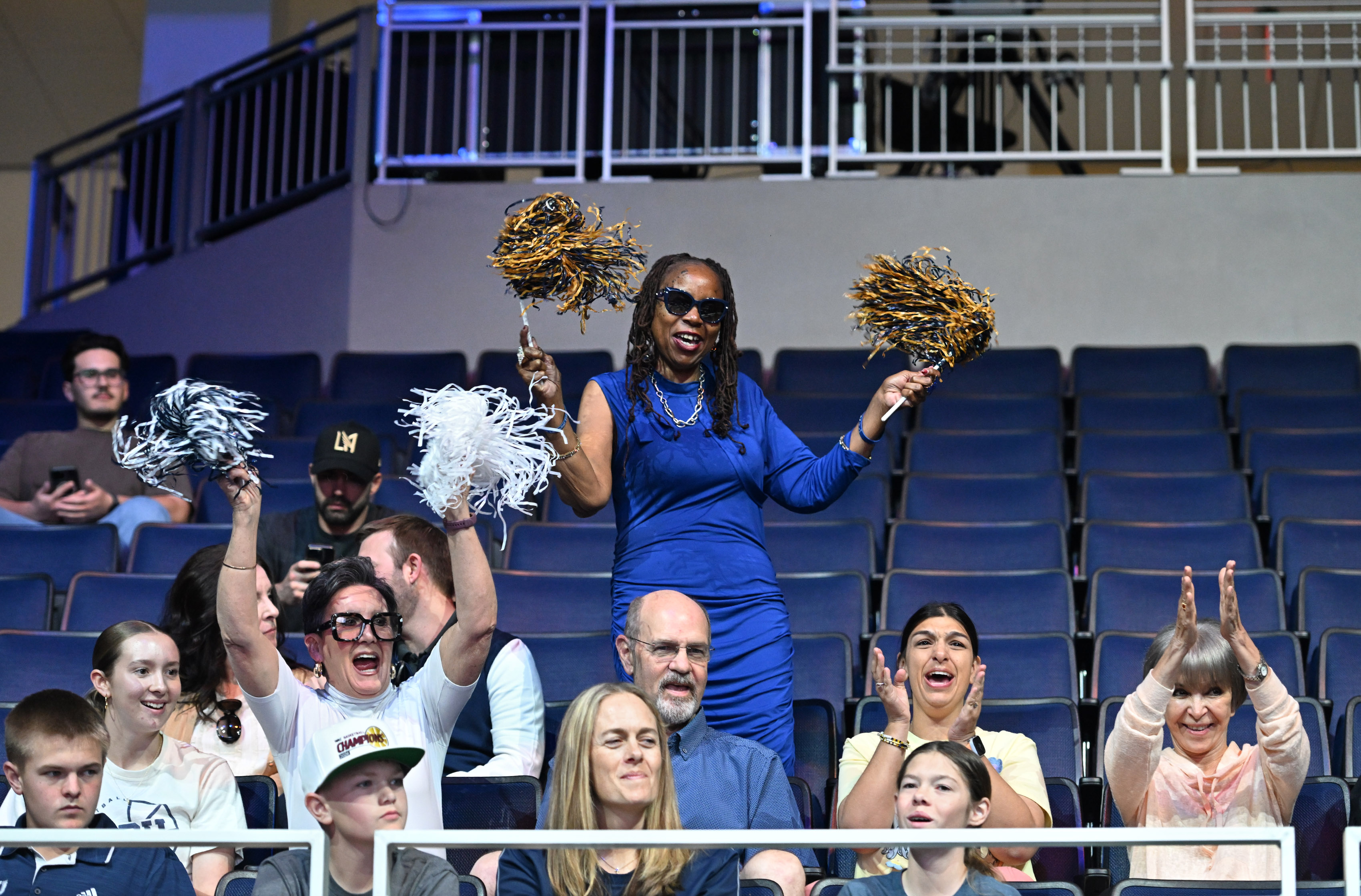 California Baptist University women’s Basketball team supporters cheer during a...