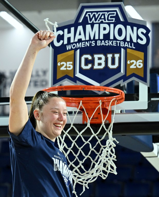 California Baptist Lancers forward Grace Schmidt (33) celebrates the team's Western Athletic Conference women's basketball league champion with a piece of the net in Riverside on Saturday, March 7, 2026. California Baptist University defeated Southern Utah 77-61 to win the Western Athletic Conference women's basketball regular-season finale. (Photo by Terry Pierson, The Press-Enterprise/SCNG)