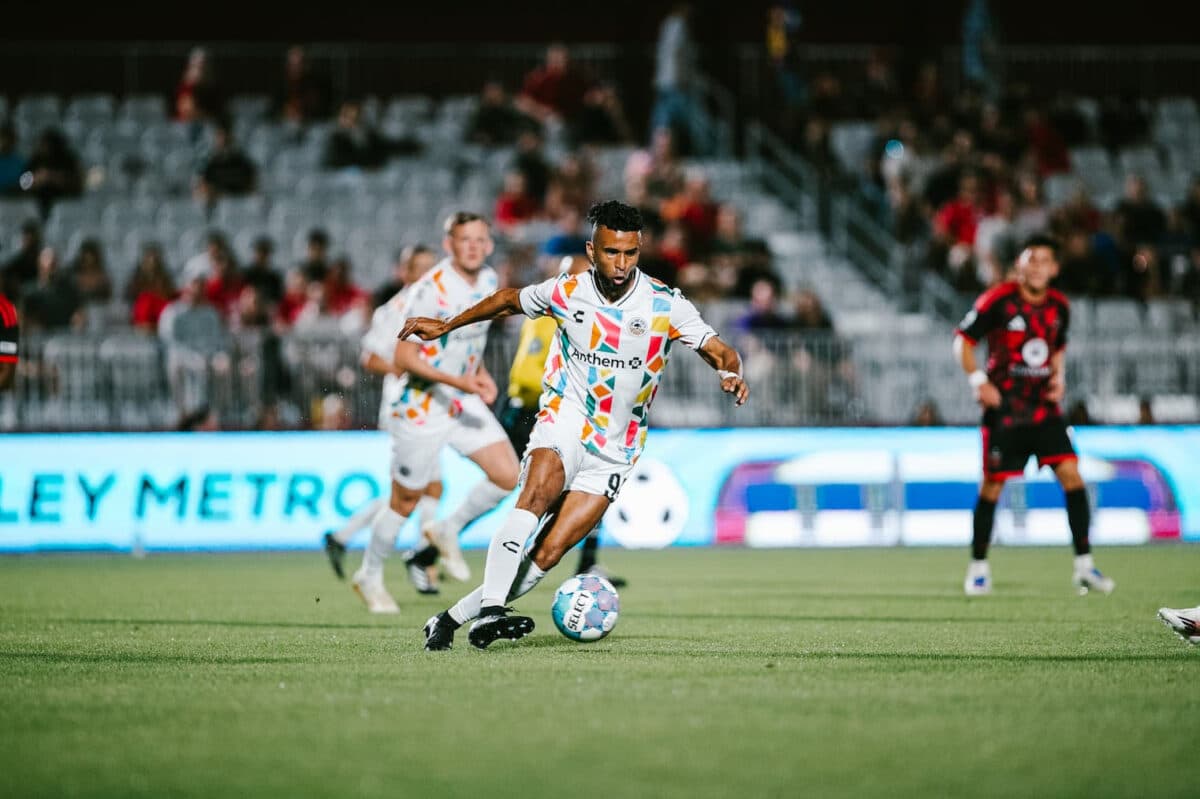 Alameda Post - An Oakland Roots player dribbles the ball in a match against Phoenix Rising. 