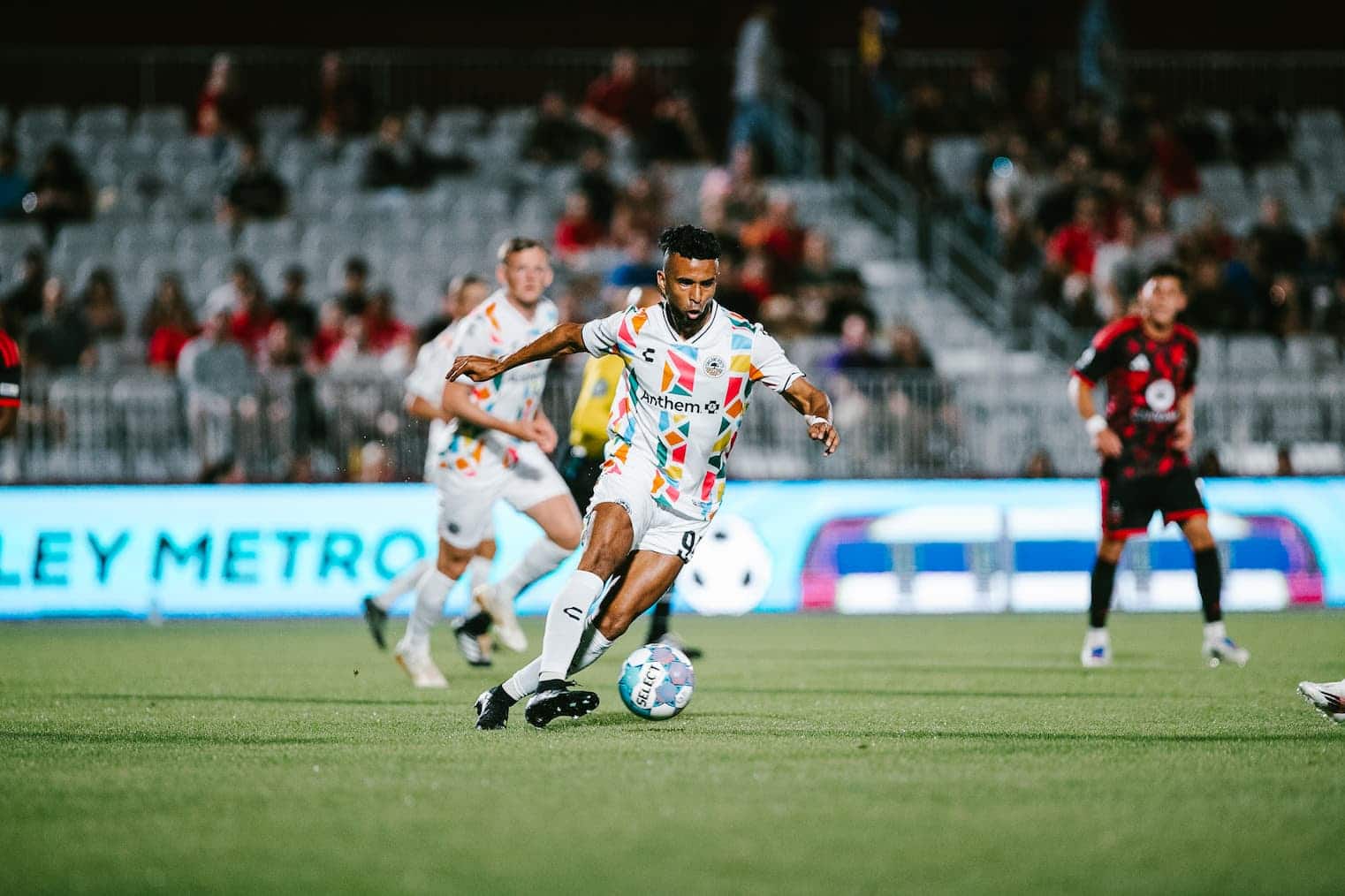 Alameda Post - An Oakland Roots player dribbles the ball in a match against Phoenix Rising.