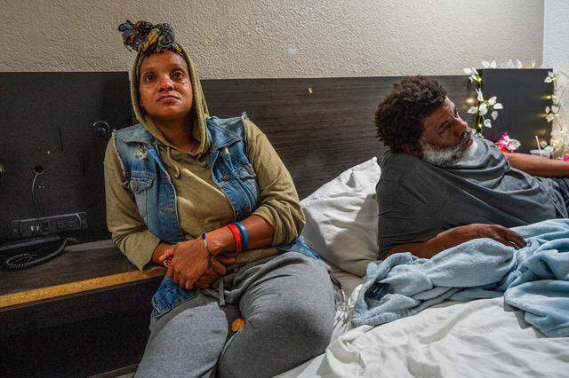 Tears stream down the face of Tanika Williams as she sits with her husband, Michael Williams, 54, on March 3, unsure how they will pay for another night’s hotel in Sacramento with their 4-year-old daughter. The family had lost their car because they couldn’t make payments, and her paycheck as a caretaker for her husband, who suffers from chronic obstructive pulmonary disease, was not due until March 15.