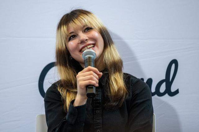 Alysa Liu speaks to the media during a news conference celebrating her Olympic success at Frank Ogawa Plaza in Oakland on Thursday. Thousands gathered to honor Liu after her gold medal in women’s figure skating at the 2026 Winter Olympics.