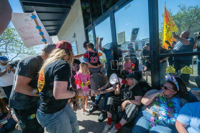 More than 1,000 teachers and parents rally at the Twin Rivers Unified School District office Friday, pounding on the entrance and staging a sit-in as they demanded that the district return to the table while the teacher strike reached its 12th consecutive day of instruction.