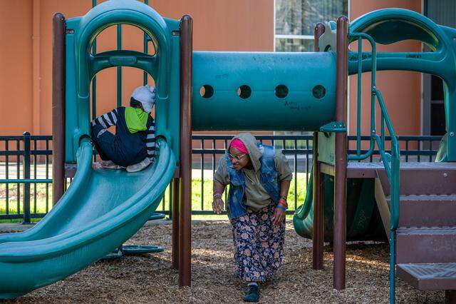 Tanika Williams, 40, plays with her daughter, Makhìla Williams, 4, at James Marshall Park in Sacramento on March 9 to help her feel a sense of normalcy as the family, who are homeless, waits for housing. So far, they have been unable to find a shelter that can take all three of them.