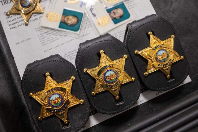 Historical vault officer badges are displayed at the Jesse M. Unruh Building in Sacramento on earlier this month. 