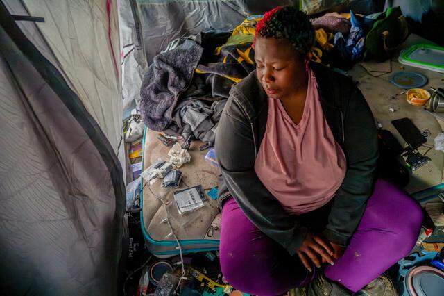 Elizabeth William sits inside her tent in South Natomas in March 2025, just one month after she was arrested for unlawful camping. Williams said that when the Sacramento police took her to jail in February 2025, they threw away her ID, debit card, Social Security card and birth certificate, making it hard to receive her tax return.