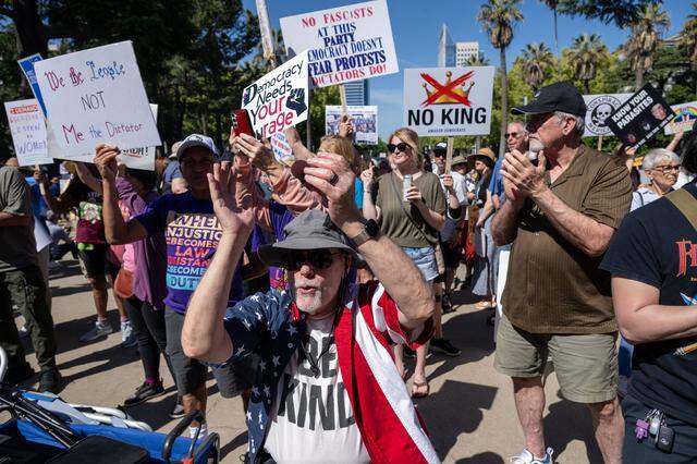 Protester Gene Romagna of Sacramento applauds during a "No Kings" rally at the state Capitol on Saturday.