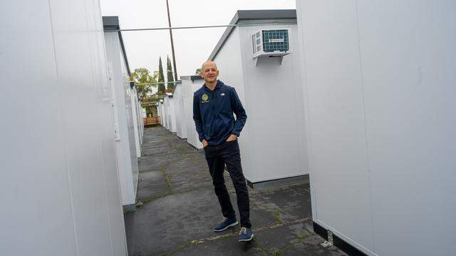 Sacramento Mayor Kevin McCarty tours the 100 new tiny homes on the north campus of the Roseville Road shelter at a news conference on Thursday, Dec. 18, 2025, regarding their completion. The homes have individual heating and air-conditioning, and half will allow pets. Another 35 tiny homes have been added to the south campus.