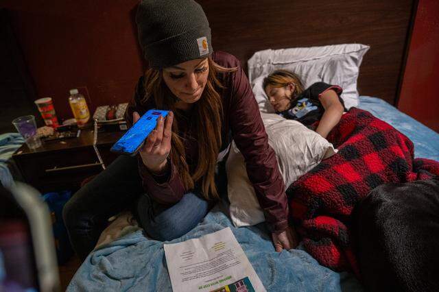 Jessica Rose listens to a dispatcher during a 211 call alongside her daughter Faith in a hotel room in Rancho Cordova on Jan. 21. The pair had slept outdoors the night before. “I have a 12-year-old daughter with me. We actually are survivors right now,” she told the dispatcher. “We escaped a very nasty situation and really have nowhere to go.” The dispatcher said family shelters were full, but they would place her on a waiting list.
