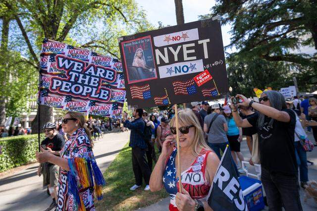 Protester Cam Essicks, left, wears a homemade outfit during the "No Kings" rally at the state Capitol in Sacramento on Saturday, March 28, 2026.