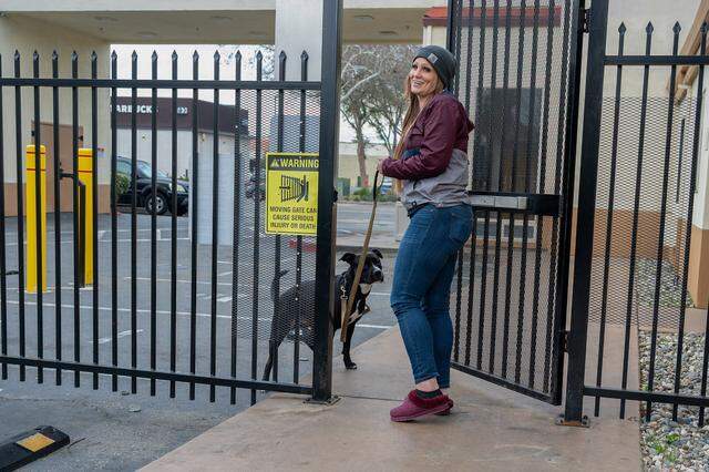 Jessica Rose, 41, goes with her service dog, Baby, to the office of the hotel they were staying at on Jan. 21 to plead for another day in the room using a vintage $100 bill her late father gave her that she didn’t want to part with. The hotel granted her the extra day and said it would allow her time to exchange the bill when she could.