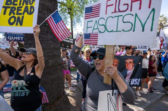 Protester Deborah Womack holds a sign that says "fight fascism" during a "No Kings" rally at the state Capitol on Saturday.