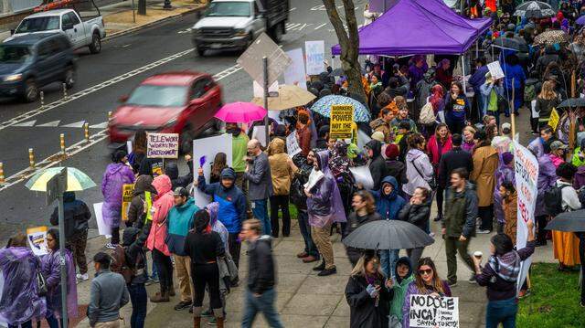 Hundreds of state workers hold signs outside the CalHR offices in Sacramento on Wednesday, March 12, 2025, to protest Gov. Gavin Newsom’s order directing them to return to their offices four days a week.