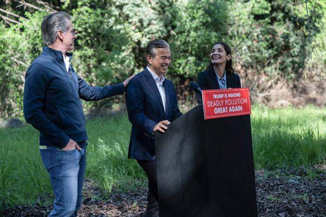 California Attorney General Rob Bonta laughs with Gov. Gavin Newsom and California Air Resources Board chair Lauren Sanchez during news conference at the California Highway Patrol Academy in West Sacramento on Thursday.