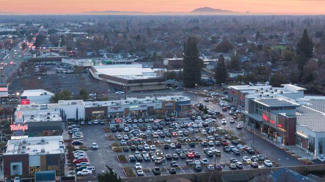 Cars fill the parking lot for Raley’s on Freeport Boulevard in Sacramento at sunset on Tuesday, Dec. 17, 2024.