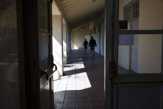 Adult education students walk down a hallway at A. Warren McClaskey Adult Center in East Sacramento earlier this month. The building, which is currently home to an adult education center, was once an elementary school.