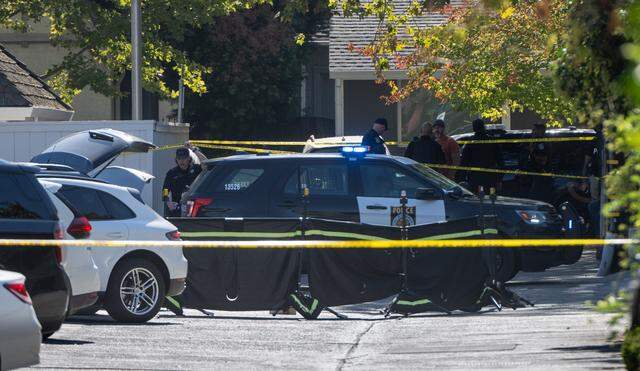 Crime scene tape and screens surround an area under investigation by Sacramento Police officers on Oct. 20, 2002, after a fatal shooting at 39th and N streets near the Sutter Lawn Tennis Club in Sacramento.