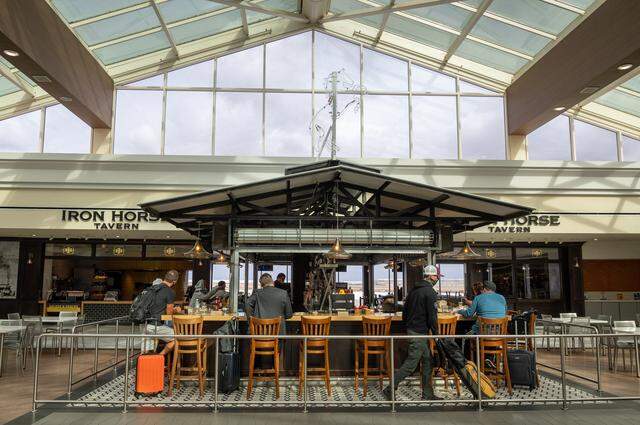 Customers eat at the Iron Horse Tavern in Terminal A at the Sacramento International Airport on Oct. 26, 2021. 