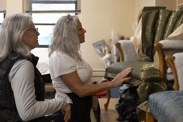 Kathy Horan, right, shows Sharon McKernan the chair she is working on in an upholstery class at A. Warren McClaskey Adult Center in East Sacramento on March 3. The class, which has turned into a club after an instructor left, will have to find a new home as the school is set to close.